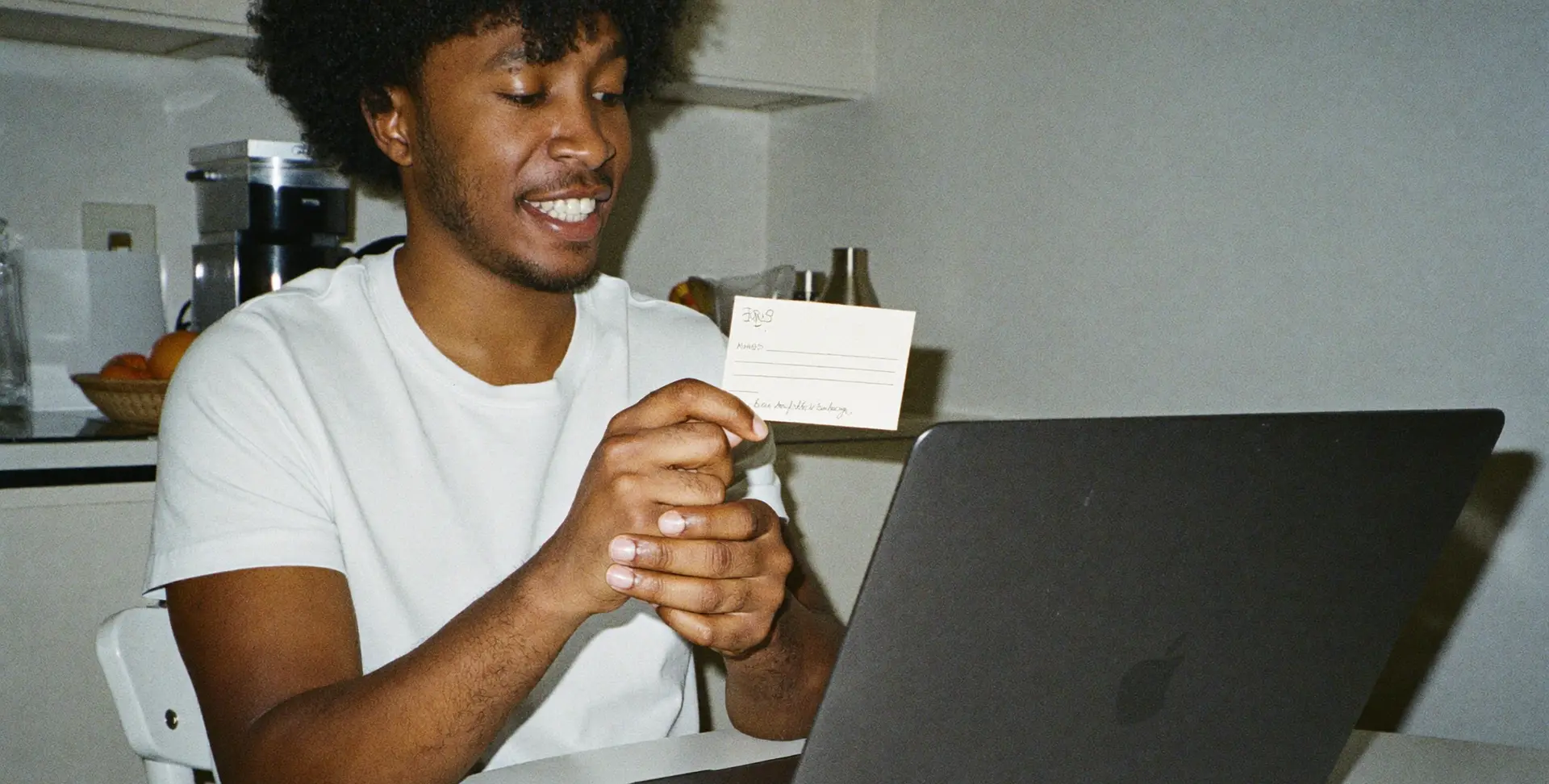 A young man practising interview answers at his kitchen table